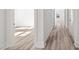 Bright hallway with hardwood floors leads to sunlit rooms, showcasing modern design and spaciousness at 133 Summerwind Dr, Summerville, SC 29486