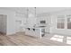Bright kitchen features white cabinetry, stainless appliances, pendant lighting, and island with bar seating at 133 Summerwind Dr, Summerville, SC 29486