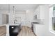 Stylish kitchen with a dark island, white cabinets, and modern lighting, offering a sleek design at 133 Summerwind Dr, Summerville, SC 29486