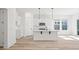 Bright kitchen features white cabinetry, stainless appliances, pendant lighting, and island with bar seating at 133 Summerwind Dr, Summerville, SC 29486
