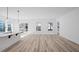 Spacious room with wood-look flooring and lots of natural light from the large window and sliding glass door at 133 Summerwind Dr, Summerville, SC 29486