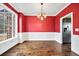 Bright dining room with hardwood floors and red accent wall at 1713 Pimlico Blvd, Moncks Corner, SC 29461