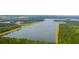 Scenic aerial view of the community lake surrounded by lush green forest and neighborhood at 360 Bering Ln, Summerville, SC 29486