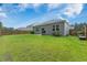 Expansive lawn of the backyard area with views of the home's exterior and a wood privacy fence at 360 Bering Ln, Summerville, SC 29486