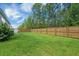 Spacious backyard with lush green grass and a wood fence, perfect for outdoor activities at 360 Bering Ln, Summerville, SC 29486
