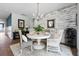 Bright dining room with a white round table, elegant chandelier, and decorative accent wall at 360 Bering Ln, Summerville, SC 29486