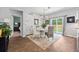 Charming dining room with white wood accent wall, chandelier, and sliding glass doors to the backyard at 360 Bering Ln, Summerville, SC 29486