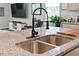 Modern kitchen features granite countertops, a stainless steel sink, and sleek black faucet at 360 Bering Ln, Summerville, SC 29486