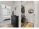 Convenient laundry area with stacked washer/dryer, storage cabinet, and modern decor at 360 Bering Ln, Summerville, SC 29486