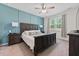 Well-lit main bedroom features blue paneled wall, a large bed, and matching nightstands at 360 Bering Ln, Summerville, SC 29486
