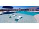 Resort-style pool with lounge chairs in the water, surrounded by umbrellas and seating areas at 360 Bering Ln, Summerville, SC 29486