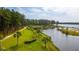 Picturesque view of the waterfront with manicured green space and towering trees at 360 Bering Ln, Summerville, SC 29486