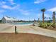 Community pool area with lounge chairs, tables, palm trees, and clubhouse for relaxing afternoons at 120 Haverhill St, Summerville, SC 29486