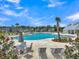 Resort-style pool with lounge chairs, tables, and lush landscaping in a beautiful community setting at 120 Haverhill St, Summerville, SC 29486