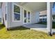 View of the back porch, featuring white columns, grass and access to the home through glass paneled double doors at 2193 Blue Bayou Blvd, Johns Island, SC 29455