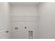 Functional laundry room with white walls, metal shelving and essential hookups for a washer and dryer setup at 120 Palfrey Dr, Ridgeville, SC 29472