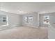 Bright living room bathed in sunlight with plush carpeting, neutral walls, and large windows that offer scenic views at 120 Palfrey Dr, Ridgeville, SC 29472