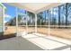 Relaxing screened porch with a concrete floor offering a tranquil retreat and views of a lush backyard at 120 Palfrey Dr, Ridgeville, SC 29472