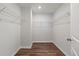 Spacious walk-in closet with hardwood floors, metal shelving, and white walls provides ample storage and organization at 120 Palfrey Dr, Ridgeville, SC 29472