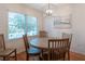 Bright dining room with round wooden table and chairs at 2 Pelican Reach # Share 10, Isle of Palms, SC 29451