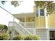 Yellow house exterior with white trim, deck, and stairs at 2 Pelican Reach # Share 10, Isle of Palms, SC 29451