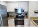 Modern kitchen with stainless steel appliances and granite countertops at 2 Pelican Reach # Share 10, Isle of Palms, SC 29451