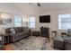 Spacious living room with grey sofa and a large TV at 2 Pelican Reach # Share 10, Isle of Palms, SC 29451