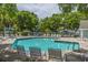 Community pool with lounge chairs and umbrellas at 2 Pelican Reach # Share 10, Isle of Palms, SC 29451