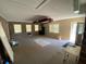 Spacious basement featuring brick accent wall, neutral carpet, multiple windows, and access to the outdoors at 1229 Central Ave, Summerville, SC 29483