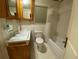 Well-lit bathroom with a tiled shower, a sink, and a toilet at 1229 Central Ave, Summerville, SC 29483