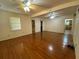 Spacious living room featuring hardwood floors, multiple windows, and ceiling fans at 1229 Central Ave, Summerville, SC 29483