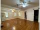 Bright living room with hardwood floors, multiple windows, and ceiling fans at 1229 Central Ave, Summerville, SC 29483