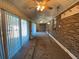 Bright sunroom featuring a ceiling fan, brick accent wall, and sliding glass doors overlooking the property at 1229 Central Ave, Summerville, SC 29483