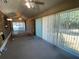 Sunroom features large sliding glass doors, neutral carpet, and a ceiling fan for a bright, airy space at 1229 Central Ave, Summerville, SC 29483