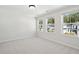 Bright bedroom featuring three windows with natural light and neutral-toned walls at 223 Abercom Place Dr, Moncks Corner, SC 29461