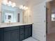 Bathroom featuring a double vanity with a large mirror and modern lighting fixtures at 427 Grove End Rd, Moncks Corner, SC 29461