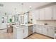Spacious kitchen showcasing white cabinetry, stainless steel appliances, an island, and an open layout into the living area at 427 Grove End Rd, Moncks Corner, SC 29461