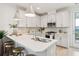 Well-lit kitchen with white cabinetry, stainless steel appliances, a breakfast bar, and modern pendant lighting at 427 Grove End Rd, Moncks Corner, SC 29461