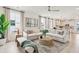 Bright living room with stylish sofas, a patterned rug, and an open view into the adjacent kitchen at 427 Grove End Rd, Moncks Corner, SC 29461