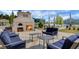 Relax by the outdoor fireplace with comfortable seating and serene community views at 386 Tupelo Lake Dr, Summerville, SC 29486