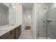 Well-lit bathroom features a walk-in shower, granite vanity, and walk in closet for convenient storage at 741 Blue Iris Way, Summerville, SC 29486