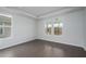 Bedroom featuring hardwood floors, large windows, and tray ceilings at 741 Blue Iris Way, Summerville, SC 29486