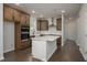 Spacious kitchen with white island, wooden cabinets and stainless steel appliances at 741 Blue Iris Way, Summerville, SC 29486