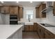 Modern kitchen with white farmhouse sink, stainless steel appliances, and custom cabinetry at 741 Blue Iris Way, Summerville, SC 29486