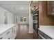 Bright living room with hardwood floors, modern cabinets, and white countertops at 741 Blue Iris Way, Summerville, SC 29486