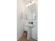 Chic powder room featuring a pedestal sink, modern fixtures, and a decorative mirror, adding a touch of elegance at 178 Cantona Dr, Summerville, SC 29483