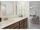 Bathroom with double vanity, granite countertops, and a view into the next room showing neutral, geometric wallpaper at 178 Cantona Dr, Summerville, SC 29483