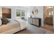 Bedroom with neutral colors, a window bench, a dresser, and an ensuite bathroom featuring granite countertops at 178 Cantona Dr, Summerville, SC 29483