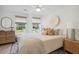 Bright bedroom with neutral colors, natural light, and a beautiful accent wall hanging decor at 178 Cantona Dr, Summerville, SC 29483