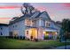 A stylish two-story home with a modern design, featuring a covered entryway and manicured lawn at 178 Cantona Dr, Summerville, SC 29483